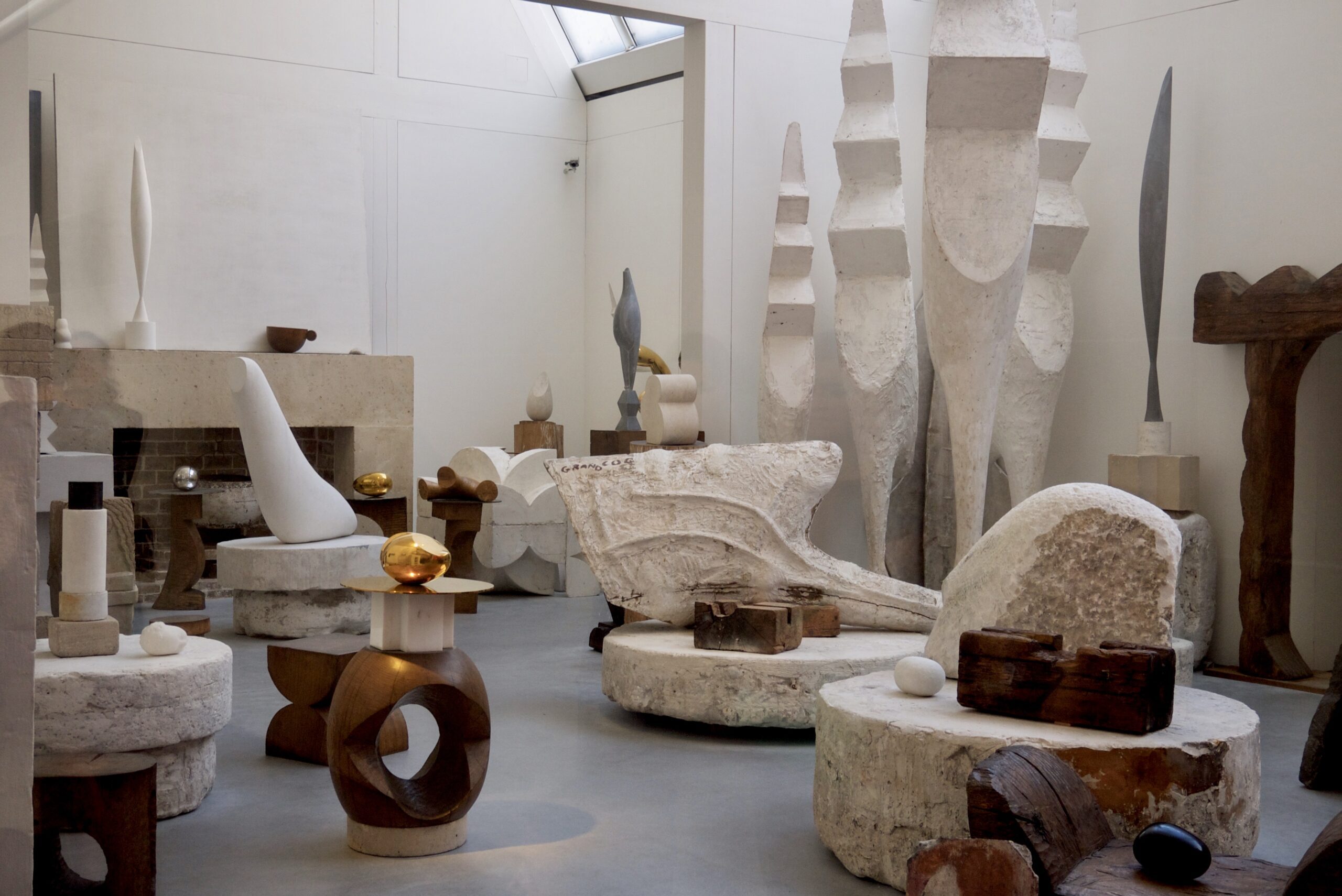 Room showcasing different sized stone sculptures at the Brancusi workshop